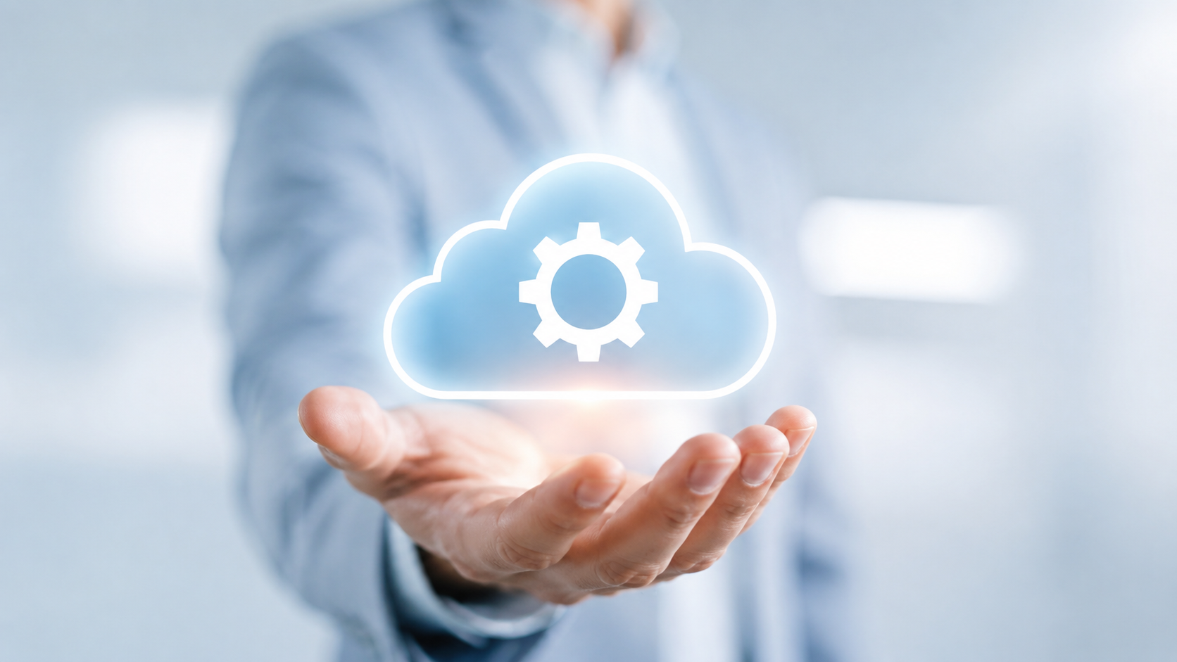 Hand holding a glowing cloud icon with a gear