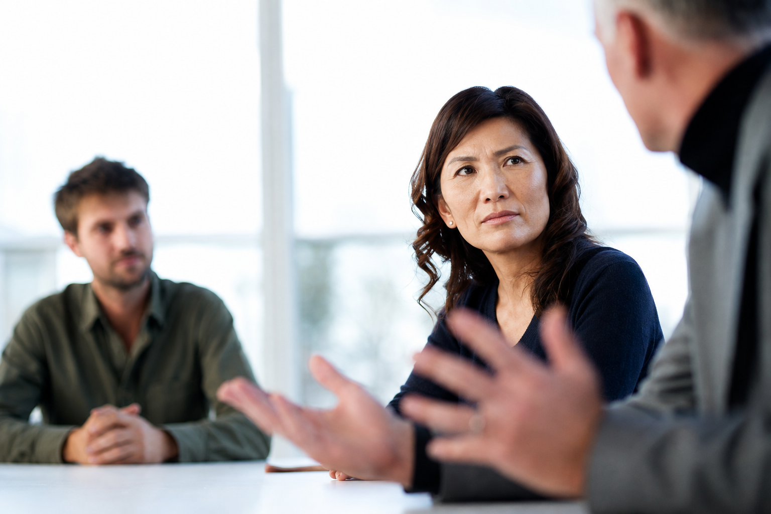 Colleagues discussing priorities in a bright meeting room